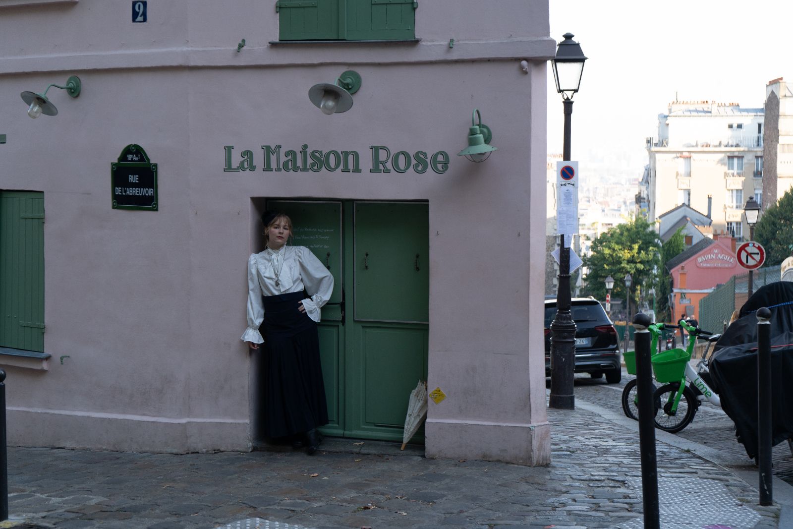 Miss Time Traveler at the door of La Maison Rose, rue de l’Abreuvoir